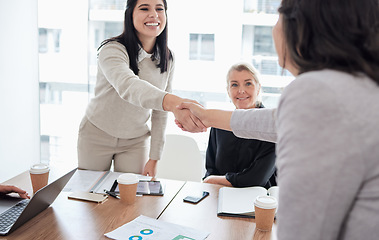 Image showing Meeting, handshake and thank you with business women in the boardroom for a b2b partnership or deal. Welcome, planning and support with happy female colleagues shaking hands in agreement at work