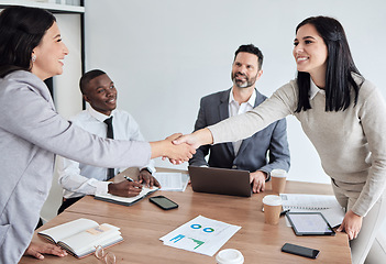 Image showing Meeting, welcome and business women shaking hands in the boardroom for a b2b partnership or deal. Thank you, handshake and support with happy female colleagues in agreement while planning at work