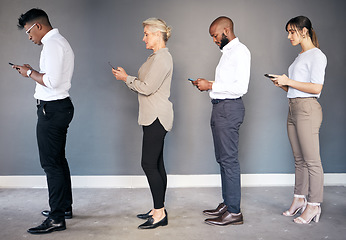 Image showing Business people, phone and networking in waiting room or line for interview, hiring or communication. Group of employees standing in row on smartphone for job search, opportunity or social media