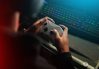 Image showing Gaming controller in hands, playing games and online streaming with gamer competition and esports. Video game tech, streamer person in dark room and play tournament with joystick and keyboard