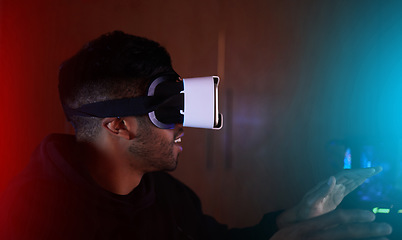 Image showing Man in dark room, video game and virtual reality, online streaming with gaming, metaverse and esports. Cyber digital world, male streamer and future technology with games, VR goggles and simulation