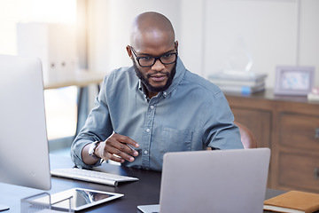 Image showing Programmer, laptop and black man reading software, coding or email in office. IT, computer and African professional working on cyber security, business or focus on research for information technology