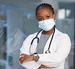 Image showing Portrait, virus and arms crossed with a doctor black woman in the hospital wearing a mask for safety. Medical, healthcare and insurance with a female medicine professional you can trust in a clinic