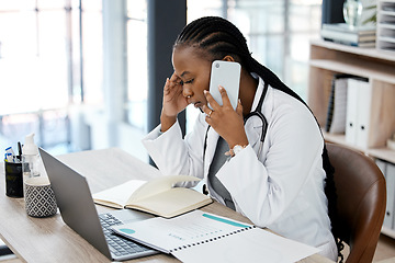 Image showing Hospital, doctor and black woman with stress on a phone call for conversation, talking and discussion. Healthcare, burnout and female worker on smartphone for medical service, consulting and help