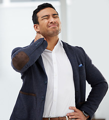 Image showing Accident, neck pain and injury with a business man standing hand on hip in his office while working. Medical, healthcare and anatomy with a male employee holding his stiff shoulder in the workplace