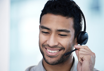 Image showing Call center, listening and business man smile for telemarketing, customer service and support in office mockup. Crm, contact us and Asian male sales agent, consultant and professional with microphone