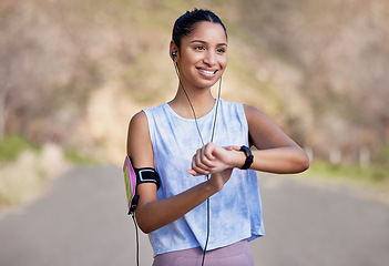 Image showing Fitness, smartwatch and woman on a break from running in the road for race or marathon training. Sports, workout and female athlete checking the time for her outdoor cardio exercise in the street.