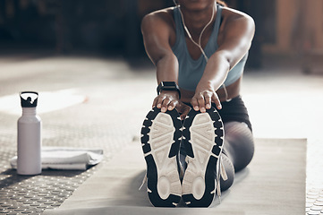 Image showing Woman is stretching in gym, fitness and feet with workout start, sneakers and sport preparation. Healthy, active with Indian female warm up and ready for exercise with flexibility on mat for training