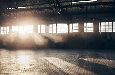 Image showing Empty, gym and interior space or dark room with window and light flare for exercise, training and fitness workout. No people, sports club and floor layout of exercising venue, facility and gymnasium