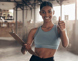 Image showing Thumbs up, clipboard and personal trainer with portrait of woman in gym for checklist, motivation and achievement. Workout, training and exercise with female bodybuilder for fitness, support and goal