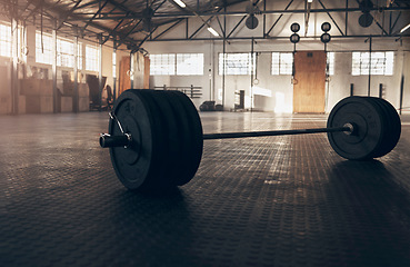 Image showing Weightlifting, fitness and barbell on floor of gym for training, workout and bodybuilding. Muscle, strong and weights with sports equipment in empty room for exercise, challenge and performance