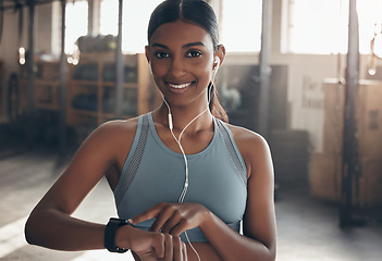 Image showing Woman, gym portrait and point at watch, fitness or schedule for workout, training or wellness. Indian girl, personal trainer and time for exercise with smile, music or audio streaming subscription