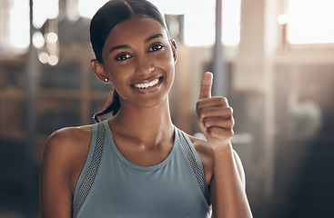 Image showing Woman in gym, thumbs up in portrait and fitness with like emoji, smile and health goals with sport and mockup space. Hand gesture, yes and motivation with Indian female athlete at exercise studio