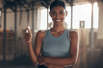 Image showing Woman in gym, thumbs up with smile in portrait, like fitness with emoji and health goals with sport and mockup space. Hand gesture, yes and motivation with Indian female athlete at exercise studio