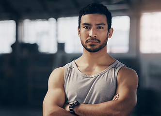 Image showing Fitness, crossed arms and portrait of a personal trainer in the gym before a workout consultation. Confidence, serious and male athlete with a strength arm exercise for biceps in a sports center.