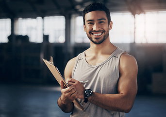 Image showing Fitness, clipboard and portrait of a personal trainer in the gym working on a training schedule. Confidence, happy and male athlete writing a workout or exercise plan for wellness in a sports center.