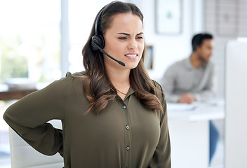 Image showing Call center, back pain and woman, agent or consultant on computer for burnout, health problem and stress. Telecom, customer support and agency worker or young person, spine or muscle injury at desk