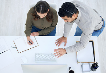 Image showing Above, call center and people in office for training together, working on desk with computer, notebook and teamwork. Businessman, woman and work in collaboration or train on pc or coach in workplace