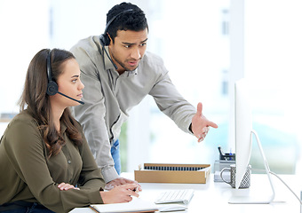 Image showing Call center, man coaching woman and advice in modern office with notes, listening and learning at telemarketing job. Crm, teaching and reading for customer service, consulting or question by computer