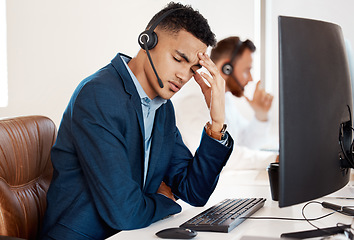 Image showing Mental health, man with headache and headset with computer at his desk of a modern office workplace. Telemarketing or customer service, burnout or depression and male person sad at his workstation