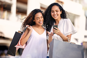 Image showing Phone, online shopping and friends or women in city, social media and reading news, sale or discount on retail website. Ecommerce, bag and happy african people on mobile app, newsletter or promo code