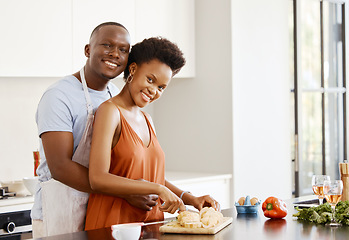 Image showing Portrait, hug and black couple in a kitchen for cooking, meal and bonding in their home together. Food, face and happy woman and man with love preparing dinner with bread, nutrition and vegetable