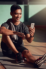 Image showing Gym, phone and happy man on floor on video call, fitness and happiness with media, exercise and chat. Internet, cellphone and workout, healthy male athlete on mat in pilates or yoga studio with smile