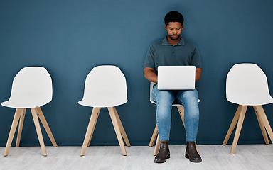 Image showing Waiting room, laptop and black man for career opportunity, creative job search and application to human resources. Young male person in queue with computer for online research, recruitment or website