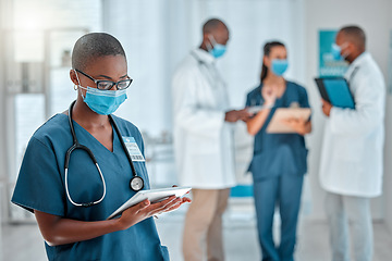 Image showing Healthcare, doctor and black woman on tablet with face mask for research, medical report and results. Hospital, clinic and female worker on digital tech for online service, consulting app or internet