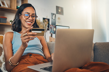 Image showing Woman on couch with laptop, credit card and online shopping, payment and ecommerce with fintech at home. Happy female customer at apartment, bank app and sale on store website with internet banking