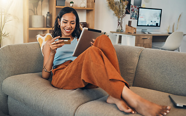 Image showing Woman on sofa with tablet, credit card and online shopping of fintech payment on ecommerce at home. Happy female customer in apartment, bank app or sale on store website with digital internet banking