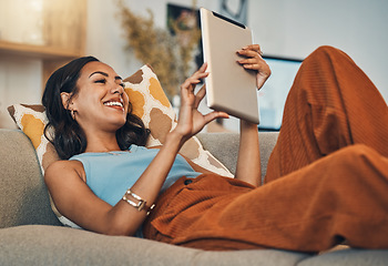 Image showing Woman relax on sofa with tablet, online streaming with internet and reading ebook or watching film at home. Happy female person with technology, subscription and mobile app with break in living room