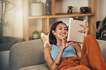 Image showing Woman relax on couch with tablet, online streaming with internet and reading ebook or watching film at home. Happy female person with technology, subscription and mobile app with break in living room