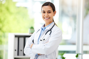 Image showing Portrait, medicine and arms crossed with a doctor woman in the hospital for insurance or treatment. Healthcare, happy or smile with a young female medical professional standing alone in a clinic