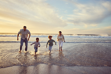 Image showing Beach, sunset and parents run with children on holiday, summer vacation and weekend together. Nature, travel and happy mother, father and kids play in ocean for bonding, adventure and family time