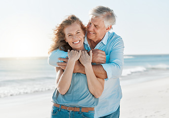 Image showing Senior, couple and portrait hug by the ocean with happiness and love on holiday in the outdoor. Mature, man and woman at the beach hugging on vacation with smile for travel together with sunshine.