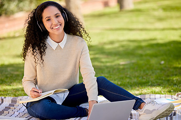 Image showing Portrait of happy woman in park studying with headphones, laptop and notes for education in nature, learning and music. Smile, research and university student on grass with audio books for project.