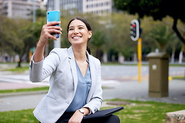 Image showing Business woman, selfie and travel with commute to work, communication and social media post in city. Young female professional, smile in picture with happiness, technology and urban with mockup space