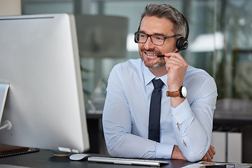 Image showing Businessman, call center and smile with headphones on computer in customer service, telemarketing or support at office. Man, consultant or agent consulting for online advice or telesales at workplace