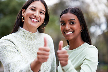 Image showing Young women, thumbs up and university students happy for education or success or like their school study as winning friends. Agreement, yes and and female scholars smile for achievement or on campus