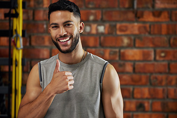 Image showing Fitness, thumbs up and portrait of man in gym, motivation and confident smile with agreement emoji. Happiness, workout and happy face of bodybuilder with winning hand gesture for health and training.