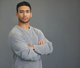 Image showing Serious portrait of man in studio with mockup, arms crossed and model on studio backdrop in casual fashion. Relax, confidence and face of male on grey background with focus, pride and mock up space.