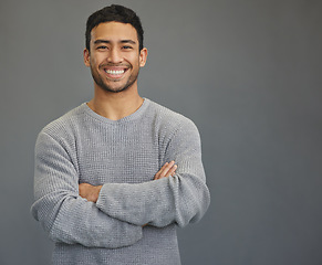 Image showing Portrait of man with mockup, arms crossed and smile on studio backdrop in confident casual fashion promo. Relax, confidence and face of male on grey background with happiness, pride and mock up space