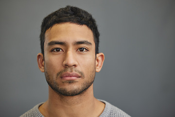 Image showing Serious man, casual and portrait with modern confidence in a studio with closeup. Male model, grey background and young person face from Philippines of a handsome Asian adult with attitude alone