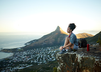 Image showing Woman, mountain and sitting with view of cityscape outdoor for exercise in Cape Town. Female hiking, cliff and South Africa for adventure in nature in the morning for wellness on the weekend.