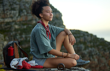 Image showing Woman, hiking and resting on a mountain top with view for wellness and fitness in south africa. Female hiker, sitting and cliff with sunset in the outdoor for adventure and exercise for relaxing.