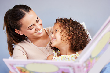 Image showing Love, book and relax with mother with daughter in bedroom for storytelling, fantasy or creative. Education, learning and smile with woman reading to girl in family home for study, happy and fairytale