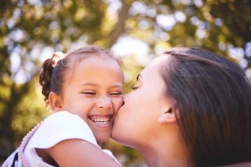 Image showing Girl, mother and kiss cheek in nature, funny and bonding on summer holiday vacation. Mom, kissing and happy child, love and affection, care and enjoying quality family time together outdoor in park.