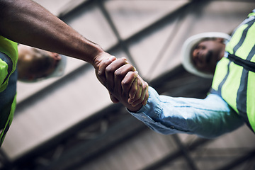 Image showing People, architect and handshake in construction, hiring or building in teamwork partnership on site. Low angle of contractor or engineer shaking hands in recruiting, architecture agreement or deal