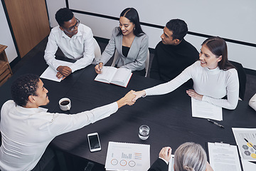 Image showing Business people, handshake and teamwork in meeting for partnership, corporate growth or deal above at the office. Happy employees shaking hands for b2b, agreement or introduction at the workplace